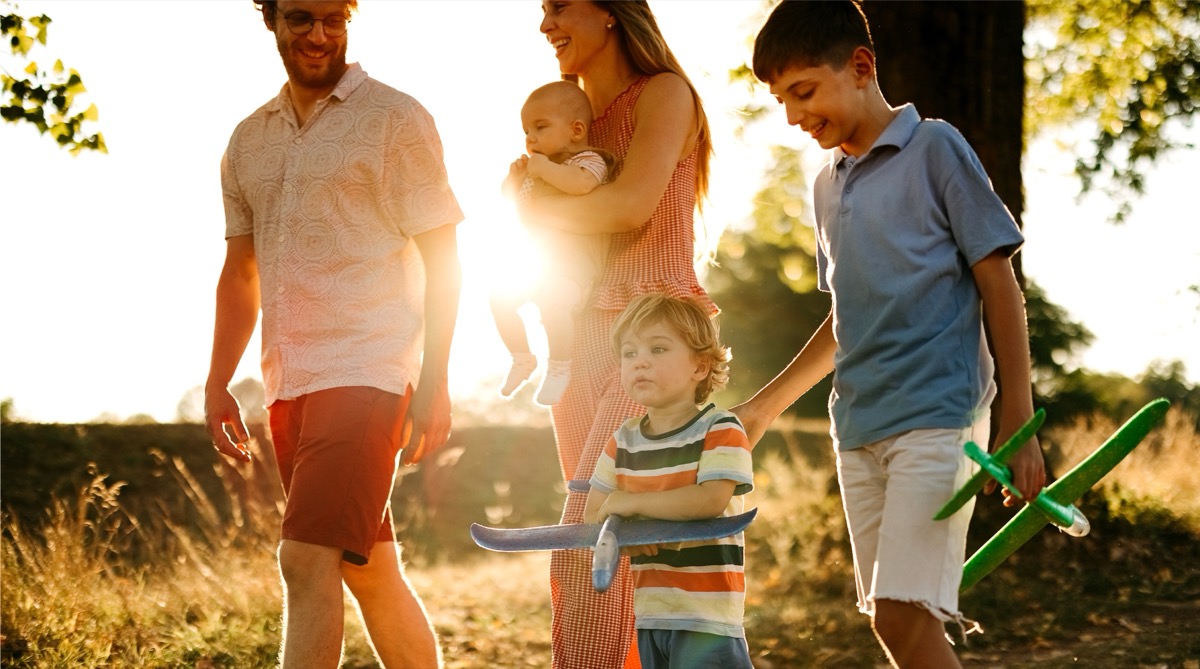 Family walking through Bolton Place community at sunset